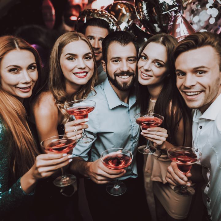 Group of people holding cocktail drinks